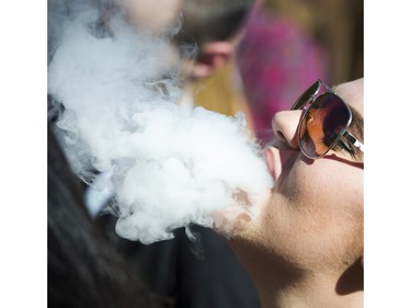 People light up at the annual 4:20 marijuana event at it's new location at Sunset Beach, Vancouver April 20 2016.