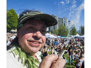 People light up at the annual 4:20 marijuana event at it's new location at Sunset Beach, Vancouver April 20 2016.