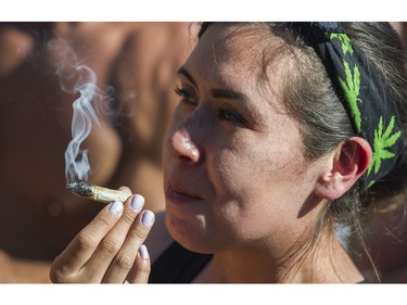 People light up at the annual 4:20 marijuana event at it's new location at Sunset Beach, Vancouver April 20 2016.