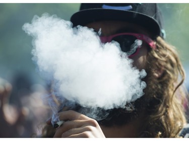 People light up at the annual 4:20 marijuana event at it's new location at Sunset Beach, Vancouver April 20 2016.