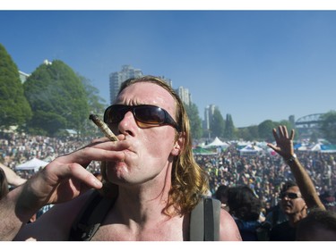 People light up at the annual 4:20 marijuana event at it's new location at Sunset Beach, Vancouver April 20 2016.