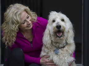 Andrea Saito poses for a photo Wednesday with her 10-year-old labradoodle Jasper, who has T-cell lymphoma.