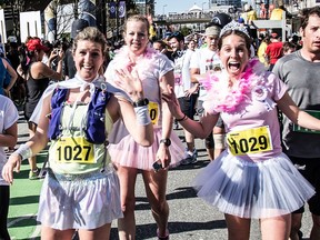 Sun Run participants  in costume cross the finish line in Vancouver on April 19, 2015.