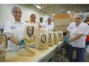 The Que Pasa foods plant in Delta has been named first zero waste certified facility in Canada. Here workers check product and quality.