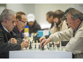 Chess enthusiasts, including Sadeghi Ahmad (left), return to the game at Park Royal Mall food court in West Vancouver, BC. April 13, 2016.