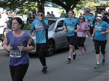 VANCOUVER, BC., April 17, 2016 --  A man drives his car on the course in the 32nd annual Vancouver Sun Run, in Vancouver, BC., April 17, 2016. (Nick Procaylo/PNG)   00042785A  [PNG Merlin Archive]