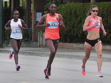 Lanni Marchant (r) leads at 3km in the 32nd annual Vancouver Sun Run, in Vancouver, BC., April 17, 2016.
