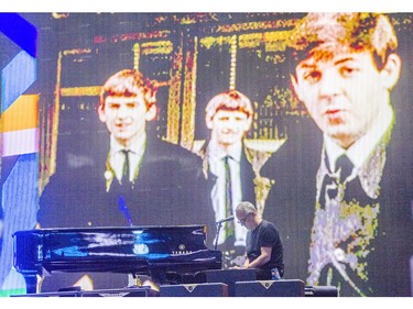 A road crew member checks the piano on the stage prior to Paul McCartney's performance at Rogers Arena in Vancouver, B.C. Tuesday April 19, 2016.