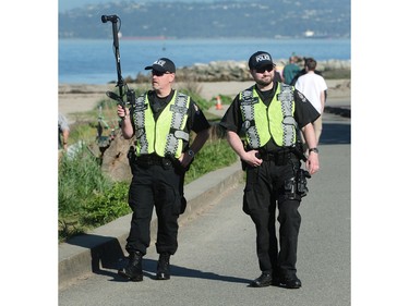 Vancouver police patrol as vendors prepare their stands for the annual 420 event at Sunset Beach in Vancouver, BC., April 20, 2016.