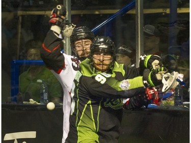 Saskatchewan Rush #90Ben McIntosh  (right) and Vancouver Stealth Matt Beers battle for the ball in National Lacrosse League action at the Langley Event Centre in Langley, BC. April 23, 2016.
