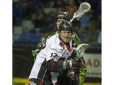 Vancouver Stealth Garrett Billings  gets by  Saskatchewan Rush Chris Corbeil in National Lacrosse League action at the Langley Event Centre in Langley, BC. April 23, 2016.
