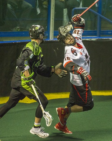 Vancouver Stealth Logan Schuss  (right) takes the ball past  Saskatchewan Rush #6  John Lintz in National Lacrosse League action at the Langley Event Centre in Langley, BC. April 23, 2016.
