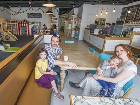 Toby Manson and his wife Anuk Harvey with their daughters Amelie Harvey Manson, 7, left, and Mila Harvey Manson, 3, relax in their Circus Play Cafe in Vancouver. (Ric Ernst Photo/PNG)