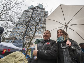 Grand Chief Stewart Phillip stands with hunger striker Kristin Henry outside B.C. Hydro's head office in downtown Vancouver on Tuesday.