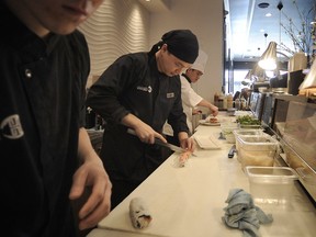 Banker turned restaurateur Caleb Lee training to be a sushi chef at his restaurant, Bistro Hatzu, in Vancouver