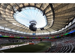 Workers open the retractable roof at BC Place Stadium in Vancouver September 20, 2011.