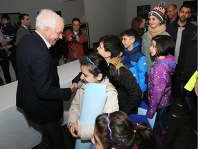 Federal Minister of Immigration John McCallum greets Syrian refugees in Vancouver.