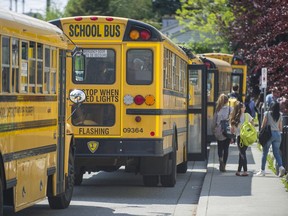 VANCOUVER. MAY 11, 2015, -  School buses outside Earl Marriott Secondary in South Surrey, B.C. May 11, 2015. for story on some districts cutting, or starting to charge for, school bus service. (Arlen Redekop photo / PNG staff)(Rob Shaw story) [PNG Merlin Archive]