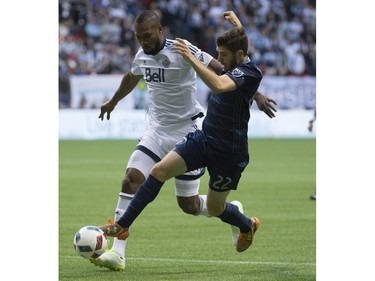 Vancouver Whitecaps defender Kendall Watson (4) fights for control of the ball with Sporting Kansas City midfielder Connor Hallisey (22) during the first half of MLS soccer action in Vancouver, B.C. Wednesday, April 27, 2015.