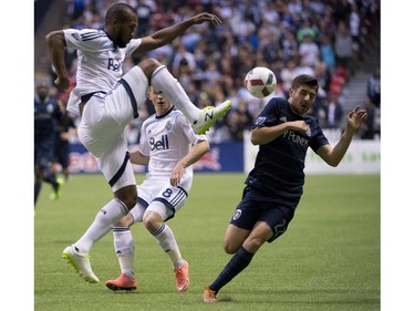 Vancouver Whitecaps defender Kendall Watson (4) tries to get the ball past Sporting Kansas City midfielder Connor Hallisey (22) during the first half of MLS soccer action in Vancouver, B.C. Wednesday, April 27, 2015.