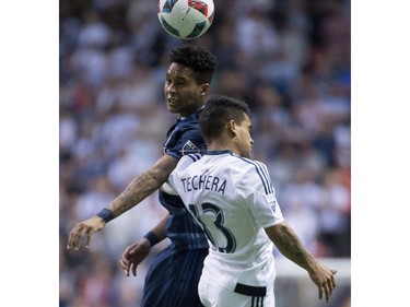 Vancouver Whitecaps midfielder Cristian Techera (13) battles in the air for the ball with Sporting Kansas City defender Amadou Dia (13) during the first half of MLS soccer action in Vancouver, B.C. Wednesday, April 27, 2015.