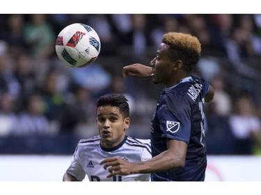 Vancouver Whitecaps midfielder Cristian Techera (13) fights for control of the ball with Sporting Kansas City defender Saad Abdul-Salaam (17) during the second half of MLS soccer action in Vancouver, B.C. Wednesday, April 27, 2015.