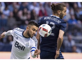 Vancouver Whitecaps midfielder Pedro Morales, left, fights for control of the ball against Sporting Kansas City defender Nuno Coelho during the first half of Major League Soccer action in Vancouver on Wednesday, April 27, 2015.