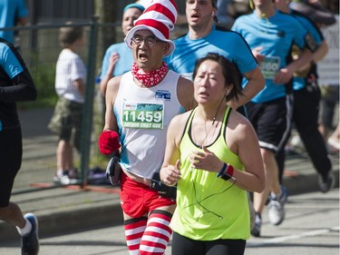 A runner dressed in a Dr. Seuss a costume runs in the 2016 Vancouver Sun.