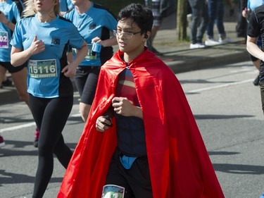 A runner runs in a superman costume during the 2016 Vancouver Sun Run.