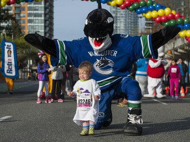 VANCOUVER,BC:APRIL 17, 2016 -- A young Sun Runner is not pleased with Vancouver Canucks' mascot Fin's appearance at the start of the 2016 Shaw Mini Sun Run run in Vancouver, BC, April, 17, 2016. (Richard Lam/PNG) (For ) 00042786A [PNG Merlin Archive]