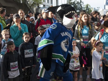 Participants of the 2016 Shaw Mini Sun Run warm up with Vancouver Canucks mascot Fin prior to the start in Vancouver, BC, April, 17, 2016.