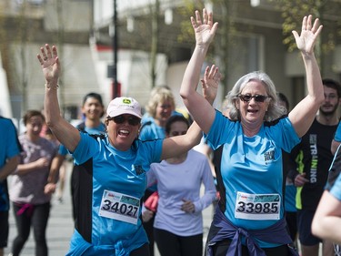 VANCOUVER,BC:APRIL 17, 2016 -- Runners celebrate after crossing the finish line of the 2016 Vancouver Sun Run in Vancouver, BC, April, 17, 2016. (Richard Lam/PNG) (For ) 00042786A [PNG Merlin Archive]