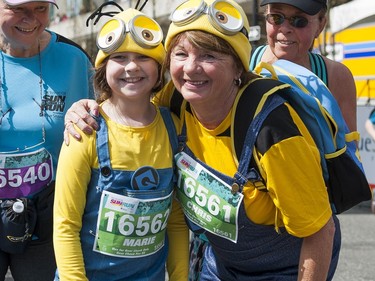Runners dressed as minions pose for a photo after crossing the finish line of the 2016 Vancouver Sun Run.