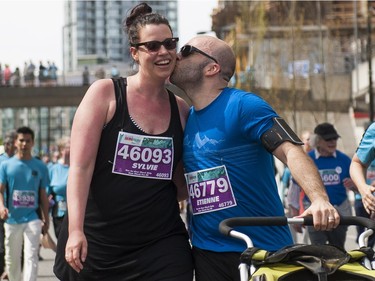 VANCOUVER,BC:APRIL 17, 2016 -- Runners kiss after crossing the finish line of the 2016 Vancouver Sun Run in Vancouver, BC, April, 17, 2016. (Richard Lam/PNG) (For ) 00042786A [PNG Merlin Archive]