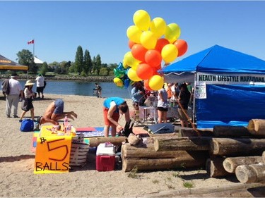 Vancouver's annual 4/20 marijuana protest had the feel of a seaside festival at its new Sunset Beach location Wednesday. Hundreds of tents stretched down both the beach and the grassy field on the other side of the seawall path as attendees browsed the merchandise on offer, enjoying the close to 20-degree weather, sunshine and sea breezes, which carried occasional, but not omnipresent, whiffs of marijuana smoke. [PNG Merlin Archive]