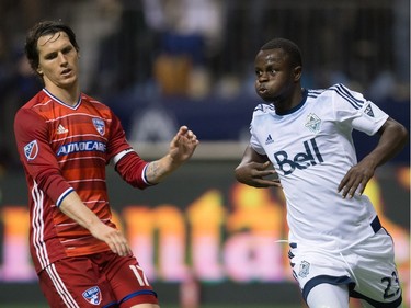 Vancouver Whitecaps' Kekuta Manneh, right, celebrates after scoring a goal as FC Dallas' Zach Loyd looks on during the second half of an MLS soccer game in Vancouver, B.C., on April 23, 2016.