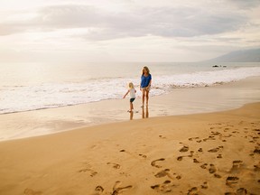 The writer and her daughter taking a stroll on one of Maui's many beaches. Anna Kim