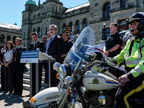 Mike Morris, B.C.s Minister of Public Safety and Solicitor General announces stricter penalties for distracted driving. To his right is Minister of Transportation Todd Stone.