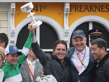 From left jockey Kent J. Desormeaux, trainer J. Keith Desormeaux, and principal owner Matt Bryan, celebrate after Exaggerator won the 141st running of the Preakness Stakes at Pimlico Race Course on May 21, 2016 in Baltimore, Maryland.