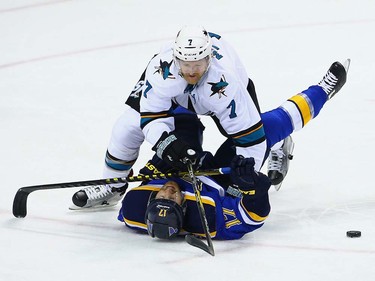 ST LOUIS, MO - MAY 23:  Paul Martin #7 of the San Jose Sharks falls on top of Jaden Schwartz #17 of the St. Louis Blues during the second period in Game Five of the Western Conference Final during the 2016 NHL Stanley Cup Playoffs at Scottrade Center on May 23, 2016 in St Louis, Missouri.  (Photo by Dilip Vishwanat/Getty Images) ORG XMIT: 639706747