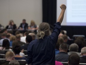 A delegate celebrates winning the vote to change the current wording of the party's same-sex marriage policy at the Conservative Party of Canada convention in Vancouver on Friday.