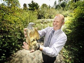 Ron Shore holding a solid gold eagle which he values at $7 million. The statue has been stolen.