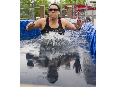 A participant reacts after jumping into the ice bath while taking part in the Woman2Warrior event at Swangard Stadium and Central Park in Burnaby, BC, May, 15, 2016. Funds raised through this all-women charity obstacle adventure race will benefit the BC Lions Society and Easter Seals camps for children with disabilities.