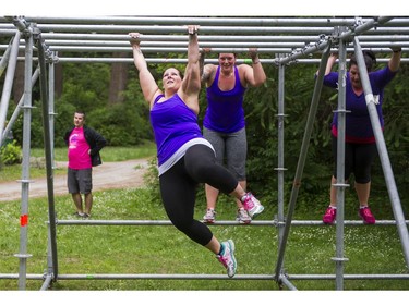 Participants in the Woman2Warrior event swing swing along the monkey bars obstacle at Swangard Stadium and Central Park in Burnaby, BC, May, 15, 2016. Funds raised through this all-women charity obstacle adventure race will benefit the BC Lions Society and Easter Seals camps for children with disabilities.