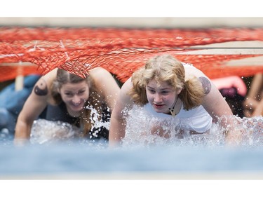 Women take on the water obstacle while taking part in the Woman2Warrior event at Swangard Stadium and Central Park in Burnaby, BC, May, 15, 2016. Funds raised through this all-women charity obstacle adventure race will benefit the BC Lions Society and Easter Seals camps for children with disabilities.