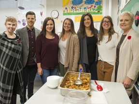 Mary-Ann Brown, principal of Douglas Road elementary (far left), and members of The Beedie Group Mason Bennett, Chelsea Virji, Stefani Burr, Bahare Poleshuk, Trisha Bouchard and Laurie Svensson pose for a photo after helping serve lunch at the school as part of the The Vancouver Sun Children's Fund Adopt-a-School initiative in November.