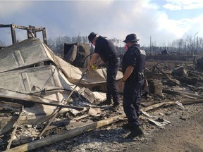 Members of the RCMP inspect burnt homes destroyed by the Fort McMurray wildfire. An app designed in B.C. promises to make disaster damage assessment much faster than the old paper and clipboard method.