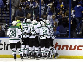 Teammates congratulate Dallas Stars' Cody Eakin on his game-winning goal during the overtime of Game 4 of the NHL hockey Stanley Cup Western Conference semifinals against the St. Louis Blues, Thursday, May 5, 2016, in St. Louis. The Stars won 3-2.