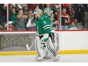 Goalie yo-yo: Antti Niemi (in front) moves in to replace fellow Finn Kari Lehtonen during an NHL game earlier this season.