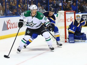 Cody Eakin of the Dallas Stars shields the puck against defender Jay Bouwmeester and goalie Brian Elliott of the St. Louis Blues during Game 3 of their NHL Western Conference semifinal series at Scottrade Center in St. Louis on Tuesday.
